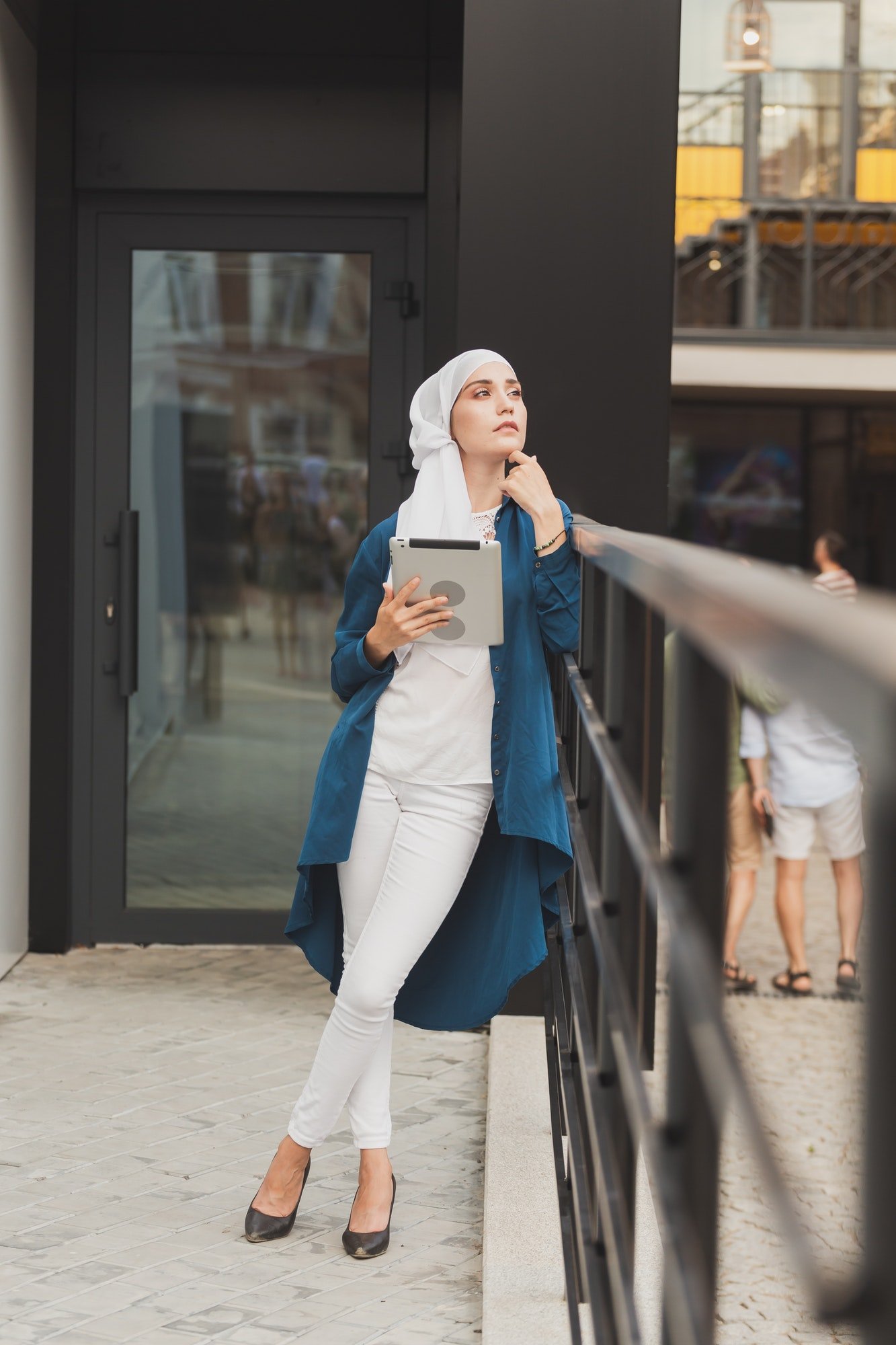 Portrait of an Arab student girl holding a tablet. Arab business woman in hijab holding a tablet in